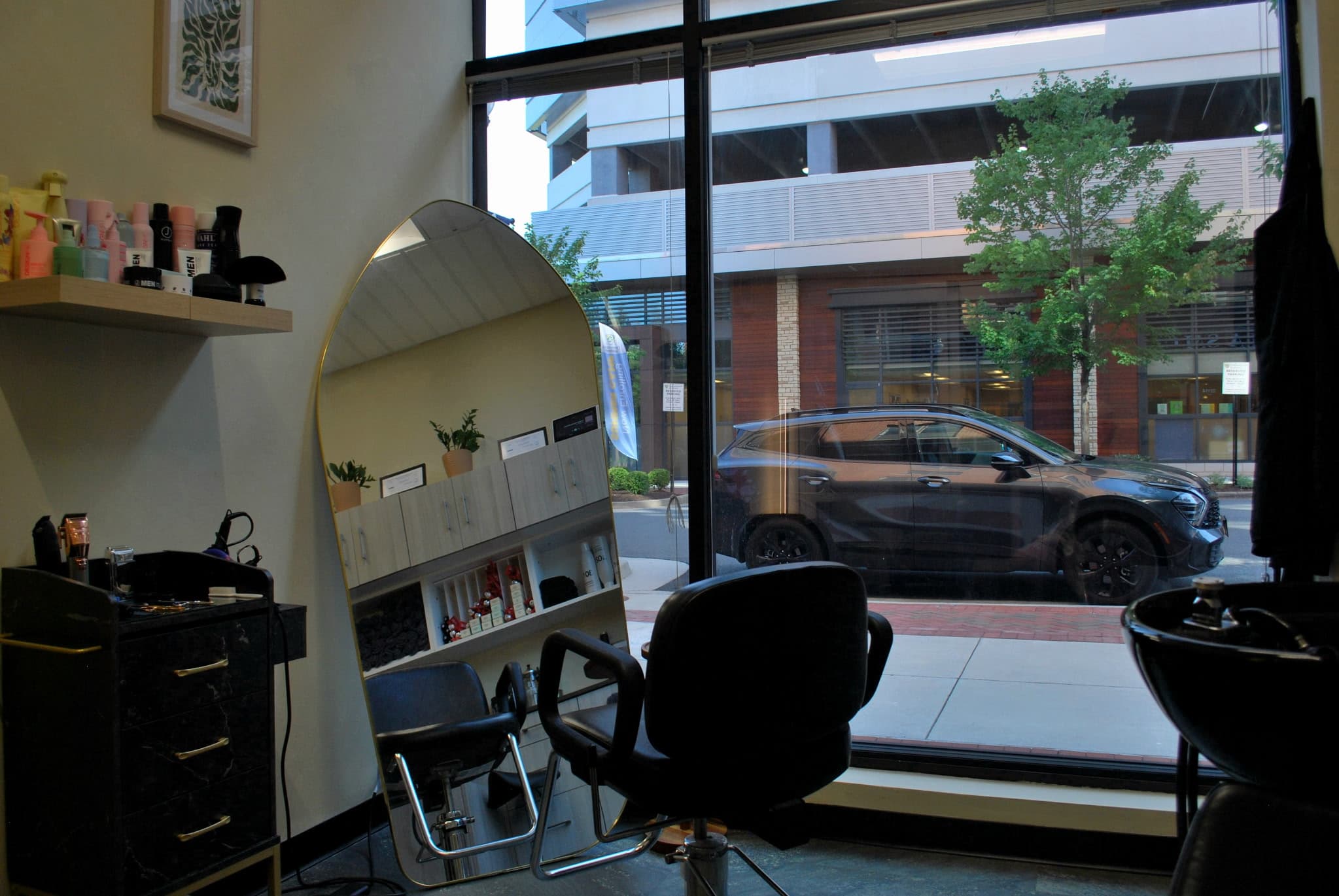 Gold arched mirror and styling chair by the studio window