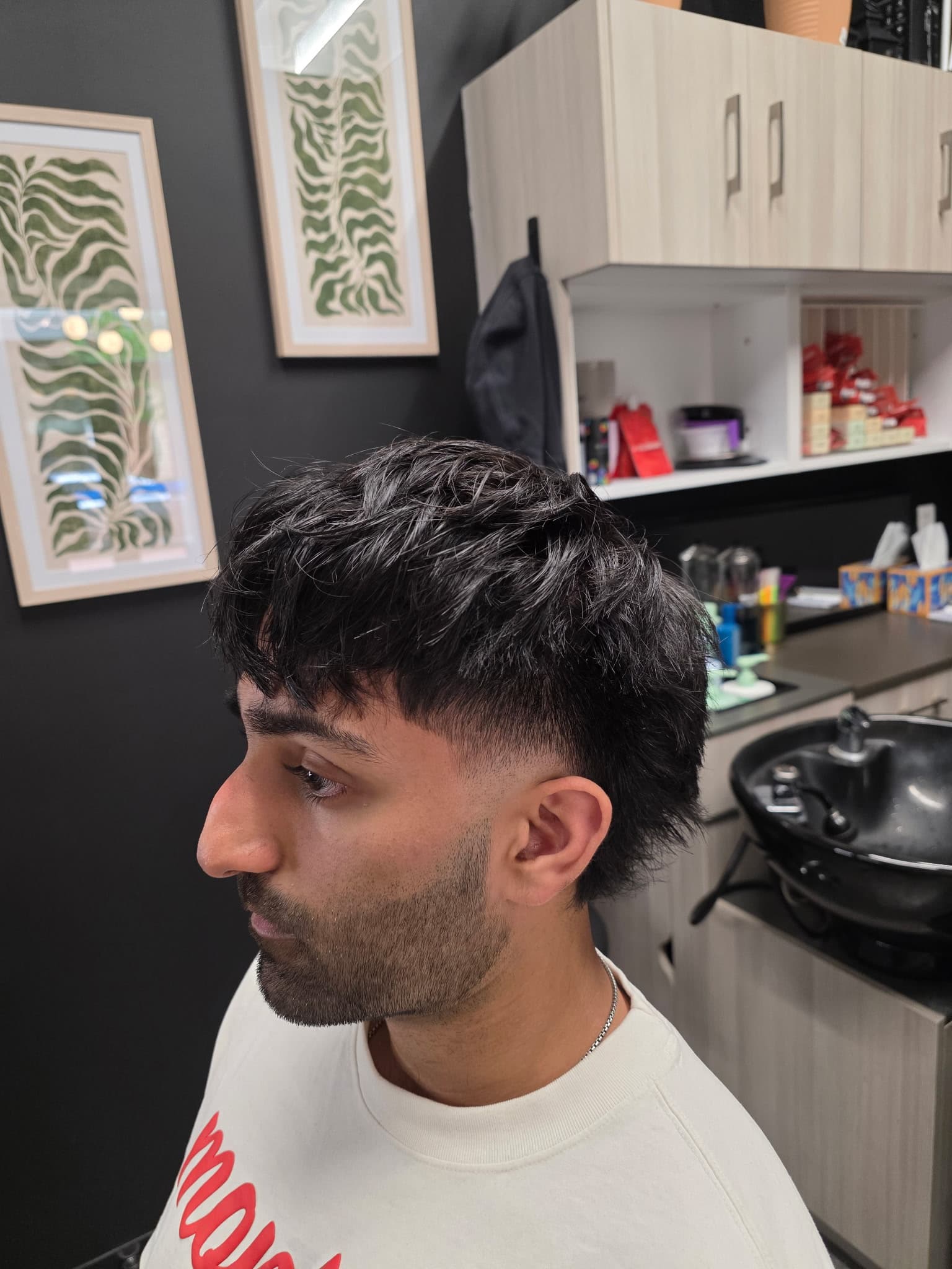 Textured crop with mid taper fade, side profile