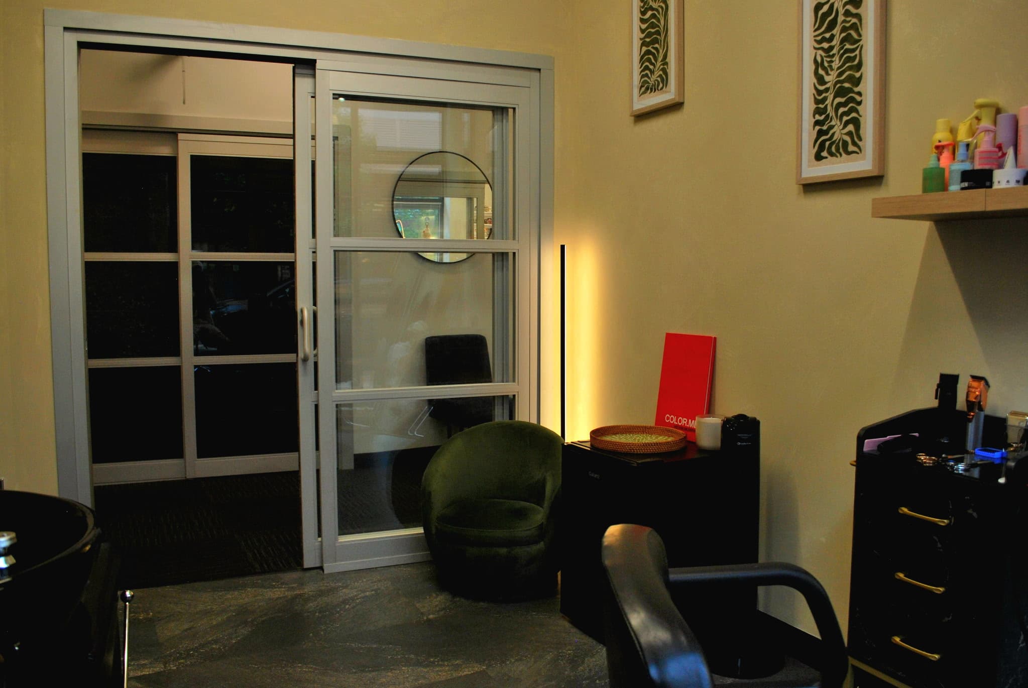 Studio lounge corner with velvet chair and accent lighting